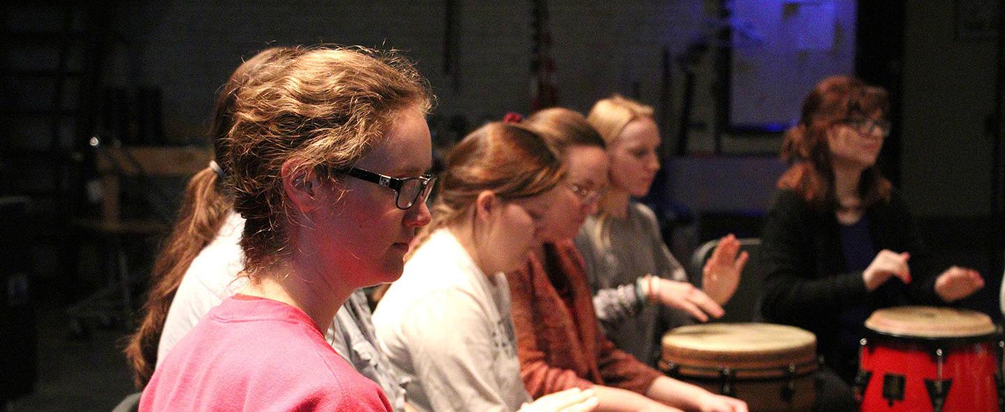 Students participating in a drum circle